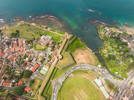 Aerial view of the historic Galle Fort and the international cricket stadium along the turquoise coastline in Galle Southern Province Sri Lanka. Aerial view of the historic Galle Fort and the international cricket stadium along the turquoise coastline in Galle Southern Province Sri Lanka.