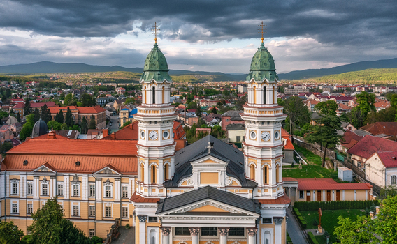 Aerial view of the Uzhhorod Greek Catholic Cathedral with its distinctive green domes standing majestically against a backdrop of rolling hills Uzhhorod Zakarpattia Oblast Ukraine. Aerial view of the Uzhhorod Greek Catholic Cathedral with its distinctive green domes standing majestically against a backdrop of rolling hills Uzhhorod Zakarpattia Oblast Ukraine.