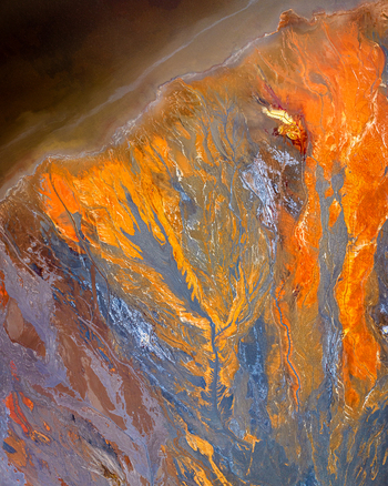 Aerial view of a vibrant mineral rich river delta with intricate branching patterns in shades of orange grey and blue in Andalusia Spain. Aerial view of a vibrant mineral rich river delta with intricate branching patterns in shades of orange grey and blue in Andalusia Spain.