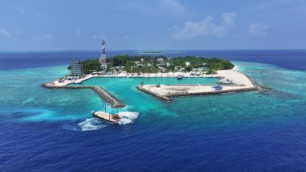 Aerial view of Kamadhoo island with its harbor and turquoise lagoon Maldives. Aerial view of Kamadhoo island with its harbor and turquoise lagoon Maldives.