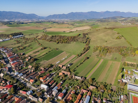 Aerial view of a patchwork of vibrant fields and the rustic village nestled amidst rolling hills Bela Dulice Zilina Region Slovakia. Aerial view of a patchwork of vibrant fields and the rustic village nestled amidst rolling hills Bela Dulice Zilina Region Slovakia.