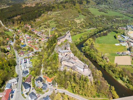 Aerial view of Orava Castle situated on a high rock above the river and lush green forests in Dolny Kubin Zilinsky kraj Slovakia. Aerial view of Orava Castle situated on a high rock above the river and lush green forests in Dolny Kubin Zilinsky kraj Slovakia.