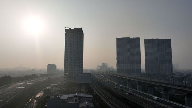 Aerial view of modern high rise apartment buildings and a multi lane highway in the urban landscape of Bekasi Barat West Java Indonesia. Aerial view of modern high rise apartment buildings and a multi lane highway in the urban landscape of Bekasi Barat West Java Indonesia.