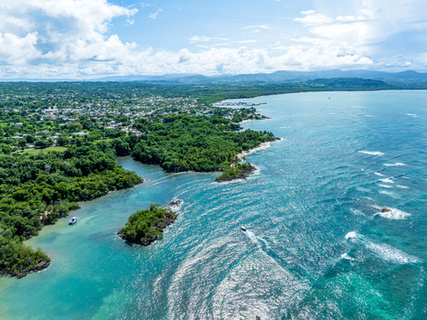 Aerial view of the coastline of Rio San Juan with turquoise waters lush green vegetation and small boats in Rio San Juan Maria Trinidad Sanchez Dominican Republic. Aerial view of the coastline of Rio San Juan with turquoise waters lush green vegetation and small boats in Rio San Juan Maria Trinidad Sanchez Dominican Republic.