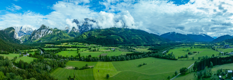 Aerial view of Nationalpark Gesause with winding rivers green valleys scattered houses and dramatic mountain peaks such as Admonter Reichenstein and Hochtor in Admont Steiermark Austria.