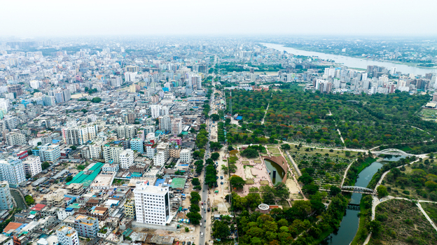 Aerial view of Rayer Bazaar Memorial surrounded by lush parkland and dense urban cityscape in Dhaka Dhaka Division Bangladesh.