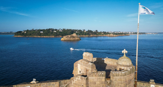 Aerial view of Chateau du Taureau s rugged stone the deep blue sea and a verdant island under a brilliant sky Plouezoc h Bretagne France. Aerial view of Chateau du Taureau s rugged stone the deep blue sea and a verdant island under a brilliant sky Plouezoc h Bretagne France.
