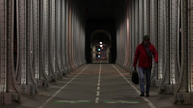 View of a man walking through the Bir Hakeim Bridge in Paris France