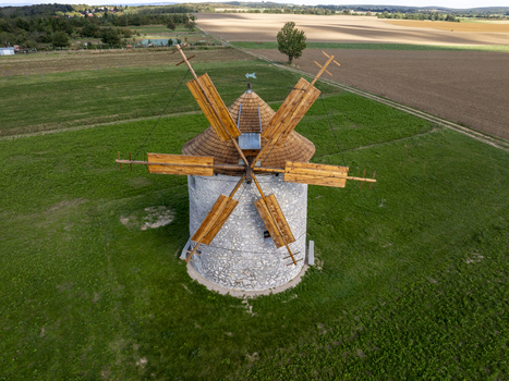 Aerial view of the historic Regi Szelmalom windmill surrounded by green fields and agricultural land in Tes Hungary. Aerial view of the historic Regi Szelmalom windmill surrounded by green fields and agricultural land in Tes Hungary.