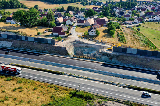 Aerial view of a highway construction site with excavators and noise barriers near a village Hochstadt Bavaria Germany. Aerial view of a highway construction site with excavators and noise barriers near a village Hochstadt Bavaria Germany.