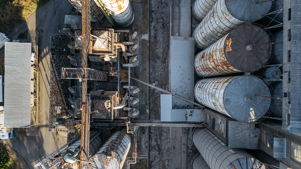 Aerial view of industrial grain silos and processing facility with metal structures and pipelines in Sremska Mitrovica Vojvodina Serbia. Aerial view of industrial grain silos and processing facility with metal structures and pipelines in Sremska Mitrovica Vojvodina Serbia.