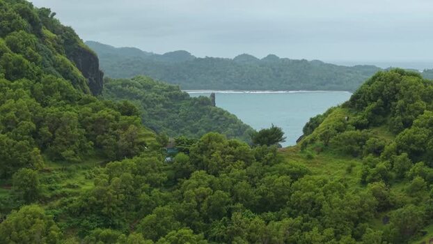 Aerial view of Bukit Pengilon and lush green coastal hills Indonesia.