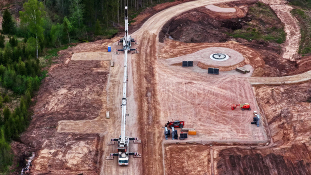 Aerial view of wind turbine base construction and concrete foundation in a forest clearing in Latvija. Aerial view of wind turbine base construction and concrete foundation in a forest clearing in Latvija.