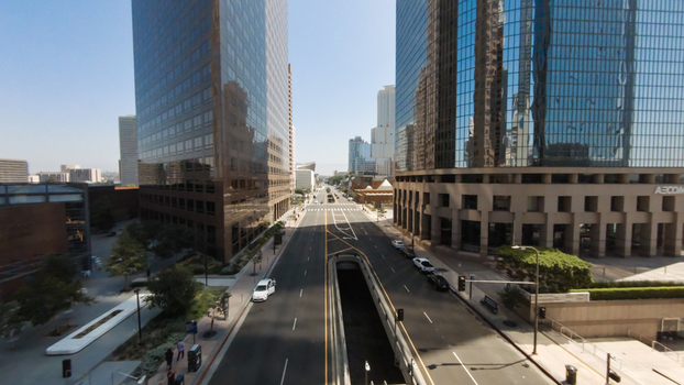 Aerial view of the modern skyscrapers and glass facade buildings lining a street with an underpass in Downtown Los Angeles California United States.
