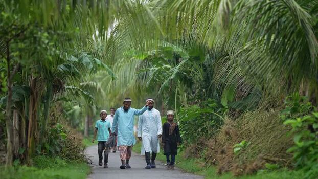 View of men and boys walking through palm trees Bangladesh. View of men and boys walking through palm trees Bangladesh.