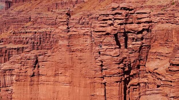 Aerial view of climbers on the red rock cliffs of Fisher Towers United States. Aerial view of climbers on the red rock cliffs of Fisher Towers United States.