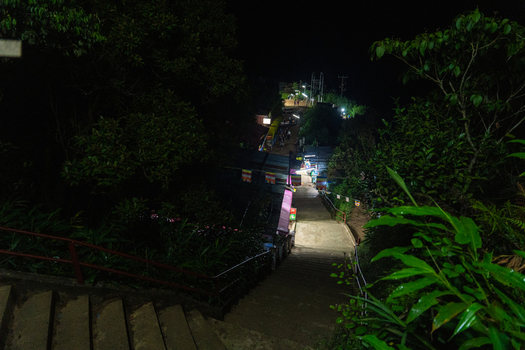 View of the illuminated pilgrimage path leading to Adam s Peak at night with concrete steps and lush vegetation in Ratnapura Sabaragamuwa Province Sri Lanka. View of the illuminated pilgrimage path leading to Adam s Peak at night with concrete steps and lush vegetation in Ratnapura Sabaragamuwa Province Sri Lanka.