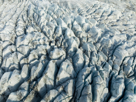 Aerial view of a frozen textured expanse a symphony of light and shadow creating a mesmerizing pattern across the glacial landscape Fjallsarlon Sveitarfélagið Hornafjörður Iceland. Aerial view of a frozen textured expanse a symphony of light and shadow creating a mesmerizing pattern across the glacial landscape Fjallsarlon Sveitarfélagið Hornafjörður Iceland.