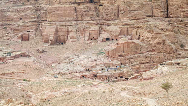 View of the ancient rock cut tombs and dwellings carved into the sandstone cliffs of the historic site in Wadi Musa Ma an Governorate Jordan. View of the ancient rock cut tombs and dwellings carved into the sandstone cliffs of the historic site in Wadi Musa Ma an Governorate Jordan.