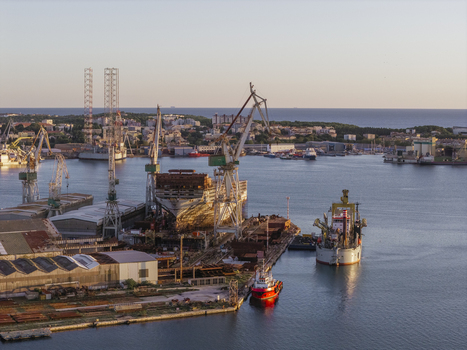 Aerial view of the Uljanik Shipyard in Pula featuring large industrial cranes a ship under construction in the dry dock and port facilities in Pula Istarska zupanija Croatia. Aerial view of the Uljanik Shipyard in Pula featuring large industrial cranes a ship under construction in the dry dock and port facilities in Pula Istarska zupanija Croatia.