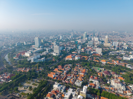 Surabaya Indonesia 29 August 2026 Aerial view of the urban landscape featuring modern high rise buildings dense residential neighborhoods with orange tiled roofs and lush green spaces. Surabaya Indonesia 29 August 2026 Aerial view of the urban landscape featuring modern high rise buildings dense residential neighborhoods with orange tiled roofs and lush green spaces.