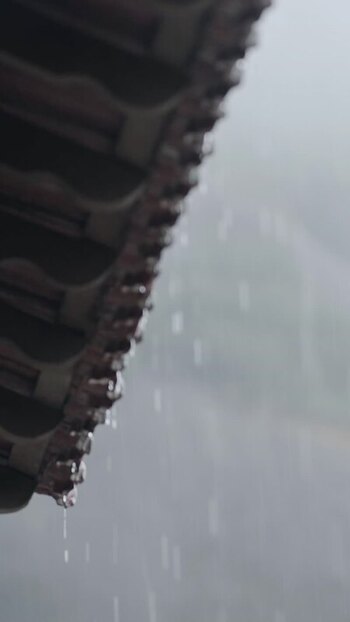 View of rain falling from a tiled roof in Brazil.