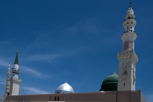 View of the minarets and the green dome of Al Masjid e Nabawi in Madinah Al Madinah Province Saudi Arabia.
