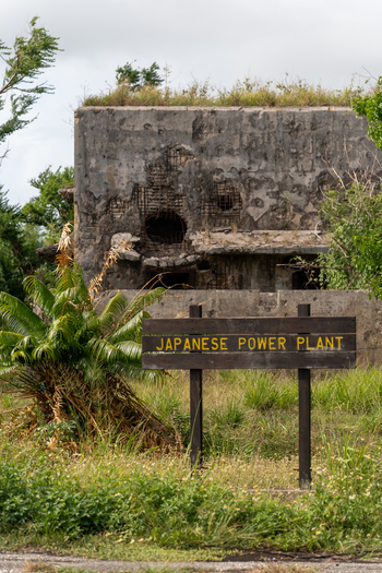 View of the historic Japanese Power Plant ruins at North Field Base featuring weathered concrete walls with battle damage in Northern Tinian Tinian Northern Mariana Islands. View of the historic Japanese Power Plant ruins at North Field Base featuring weathered concrete walls with battle damage in Northern Tinian Tinian Northern Mariana Islands.