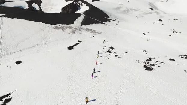 Aerial view of people trekking on snowy Mount Etna Italy. Aerial view of people trekking on snowy Mount Etna Italy.