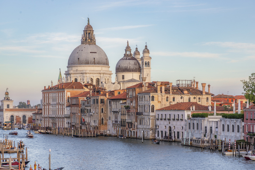 View of the Santa Maria della Salute basilica overlooking the Grand Canal with historic Venetian architecture and boats in the water in Venice Veneto Italy. View of the Santa Maria della Salute basilica overlooking the Grand Canal with historic Venetian architecture and boats in the water in Venice Veneto Italy.