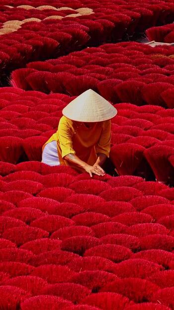 View of a person among red incense sticks Vietnam.