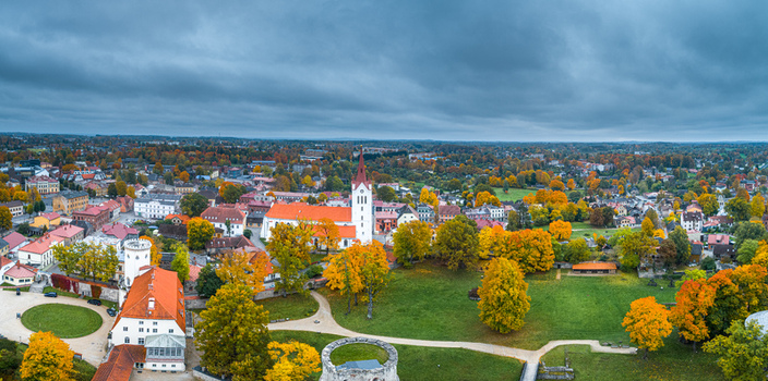 Aerial view of Cesis Castle and St. John s Church surrounded by vibrant autumn foliage and historic buildings in the town of Cesis Cesis Municipality Latvia. Aerial view of Cesis Castle and St. John s Church surrounded by vibrant autumn foliage and historic buildings in the town of Cesis Cesis Municipality Latvia.
