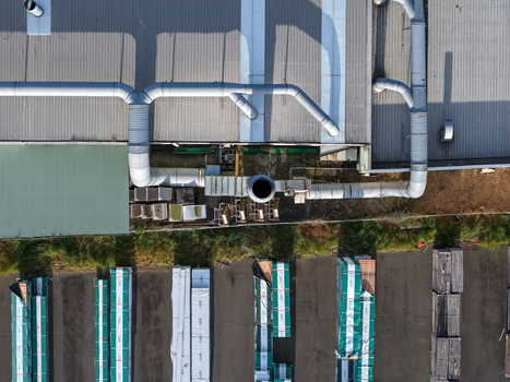Melbourne VIC Australia 22 September 2026 Aerial view of industrial factory buildings in Kilsyth with metal roofing ventilation pipes and stacks of timber materials in the yard. Melbourne VIC Australia 22 September 2026 Aerial view of industrial factory buildings in Kilsyth with metal roofing ventilation pipes and stacks of timber materials in the yard.