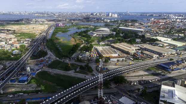 Aerial view of the Wole Soyinka Centre for Culture and Creative Arts National Theatre Nigeria surrounded by highways and the city skyline in Lagos Lagos Nigeria.