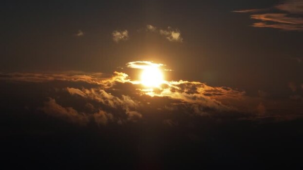 View of the sun setting behind dramatic clouds Bangladesh.