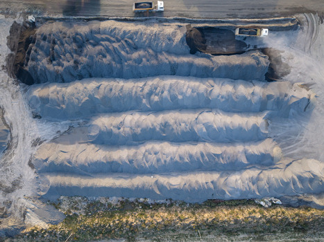 Aerial view of large piles of gravel and sand at an industrial site with trucks parked nearby in Istanbul Istanbul Turkiye.