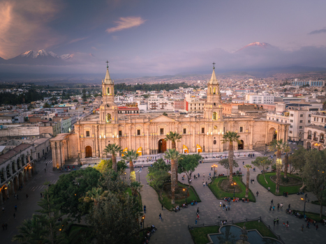 Aerial view of the Arequipa Cathedral in the Plaza de Armas with palm trees historic colonial architecture and the Misti volcano in the background in Arequipa Arequipa Peru. Aerial view of the Arequipa Cathedral in the Plaza de Armas with palm trees historic colonial architecture and the Misti volcano in the background in Arequipa Arequipa Peru.