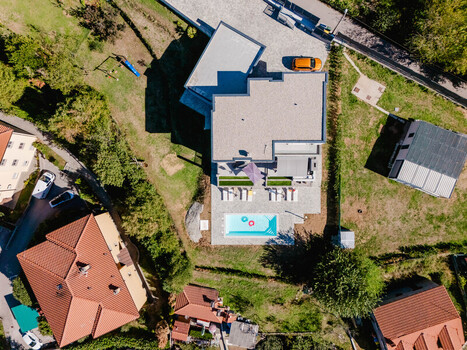 Aerial view of a modern villa with a swimming pool sun loungers and a landscaped garden in Marcelji Primorje Gorski Kotar Croatia.