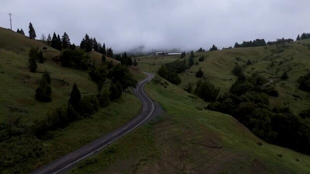 Aerial view of a winding road through green hills United States. Aerial view of a winding road through green hills United States.