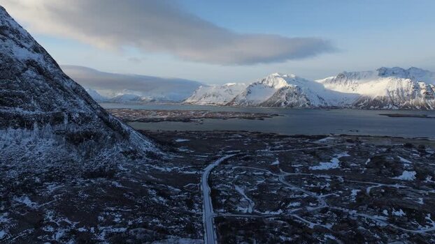 Aerial view of Lofoten mountains and snowy road Norway.
