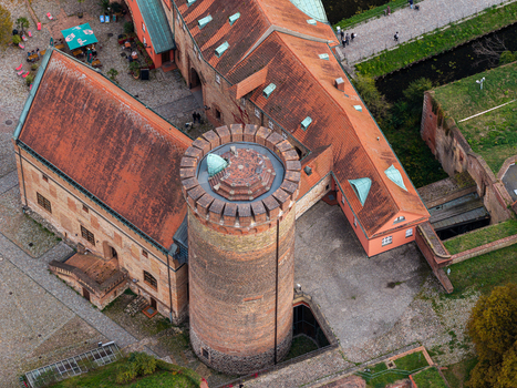 Aerial view of Spandau Citadel with its historic brick tower and surrounding red tiled roofs in Berlin Berlin Germany.