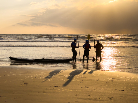 View of people with a kayak standing on the sandy shore during a golden sunset at Strand Wijk aan Zee Wijk aan Zee North Holland Netherlands. View of people with a kayak standing on the sandy shore during a golden sunset at Strand Wijk aan Zee Wijk aan Zee North Holland Netherlands.