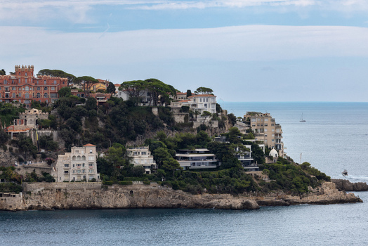 Aerial view of luxury villas nestled among lush pine trees on the rocky cliffs overlooking the Mediterranean Sea in Nice Provence Alpes Cote d Azur France. Aerial view of luxury villas nestled among lush pine trees on the rocky cliffs overlooking the Mediterranean Sea in Nice Provence Alpes Cote d Azur France.
