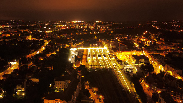 Aerial view of illuminated railway station at night with surrounding urban buildings and street lights in Pontoise Ile de France France. Aerial view of illuminated railway station at night with surrounding urban buildings and street lights in Pontoise Ile de France France.