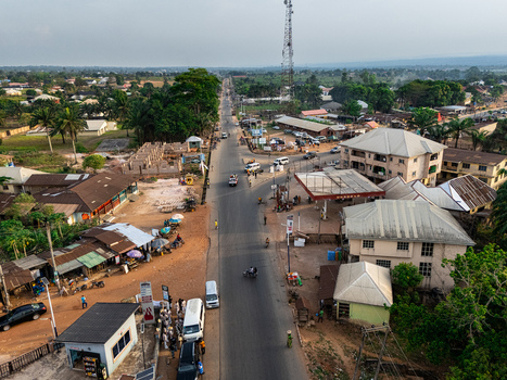 Aerial view of a bustling road stretches through Elu framed by buildings and lush greenery under a soft sky Arochukwu Isiama Ohafia Road Elu Abia Nigeria. Aerial view of a bustling road stretches through Elu framed by buildings and lush greenery under a soft sky Arochukwu Isiama Ohafia Road Elu Abia Nigeria.