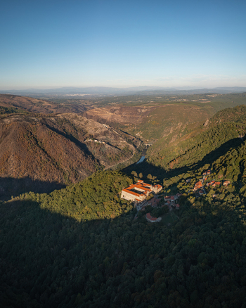 Aerial view of the Monastery of Santo Estevo de Ribas de Sil nestled in the lush green hills of the Ribeira Sacra valley in O Covelo Ourense Spain.