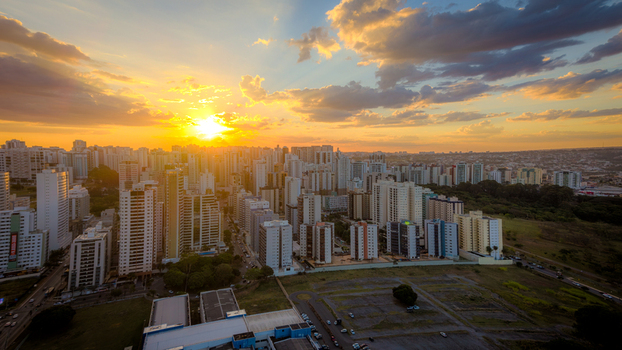 Brasilia Brazil 12 September 2026 Aerial view of the modern skyline with high rise buildings illuminated by the warm golden hour light under a dramatic sunset sky.