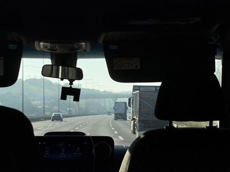 View of traffic moving along a multi lane highway with trucks and cars under a bright morning sun seen from inside a vehicle Sariyer Istanbul Turkiye.