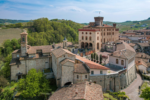 Aerial view of Castello Falletti di Barolo and the parish church with historic stone walls and terracotta roofs Barolo Piedmont Italy. Aerial view of Castello Falletti di Barolo and the parish church with historic stone walls and terracotta roofs Barolo Piedmont Italy.