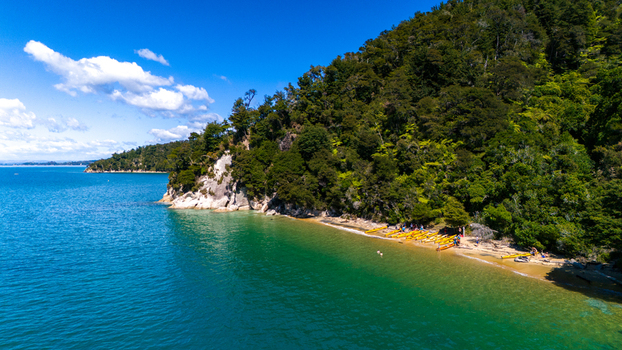 Aerial view of the coastline where lush green forests meet the turquoise sea Abel Tasman National Park Tasman Region New Zealand. Aerial view of the coastline where lush green forests meet the turquoise sea Abel Tasman National Park Tasman Region New Zealand.